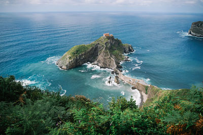 High angle view of rocks in sea against sky