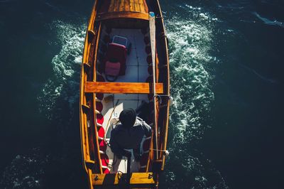 Directly above shot of man sailing on boat in sea