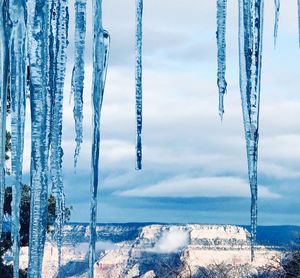 Panoramic shot of icicles hanging against sky