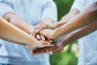 Midsection of couple holding hands