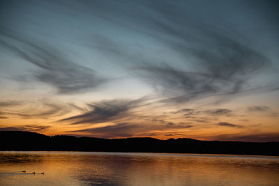 Scenic view of lake against sky during sunset