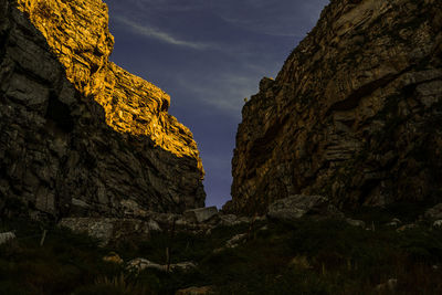 Low angle view of rock formation against sky