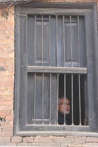 Man standing against window