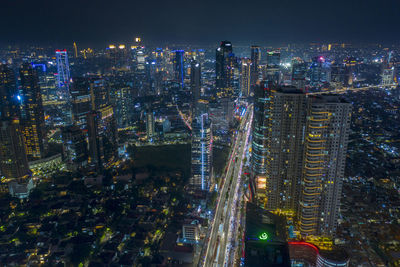 Aerial view of buildings in city against sky