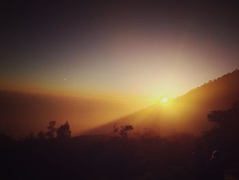 Scenic view of silhouette landscape against sky during sunset