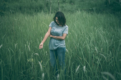 Man standing on grass in field