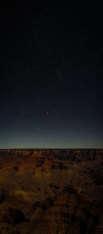 Scenic view of landscape against sky at night