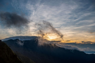 Scenic view of mountains against sky during sunset