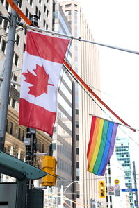 Low angle view of flag against buildings in city