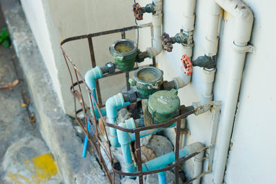 High angle view of old pipes on wall