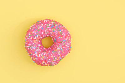 Directly above shot of multi colored candies against orange background