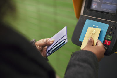 Woman paying for ticket with credit card