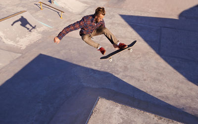 Full length of man skateboarding at park