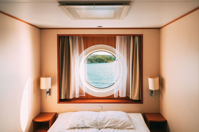 View of bed in bedroom in cruise ship