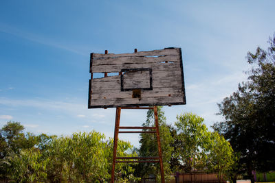 Low angle view of old basketball hoop against sky