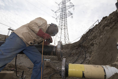 Side view of man working on street during winter