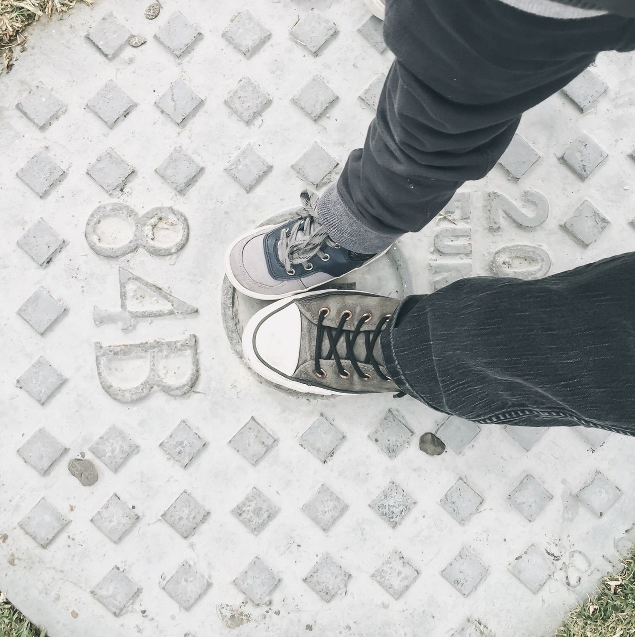 low section, person, lifestyles, shoe, high angle view, men, standing, leisure activity, street, human foot, unrecognizable person, sidewalk, walking, tiled floor, day, cobblestone