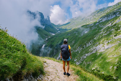 Rear view of woman walking on trail