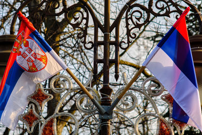 Low angle view of flags hanging on building