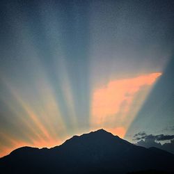 Scenic view of mountains against sky at sunset