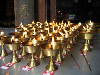 Close-up of illuminated candles in temple