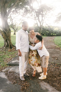 Rear view of couple standing on field