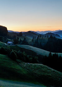 Scenic view of landscape against clear sky during sunset