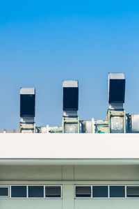 Low angle view of building against clear blue sky