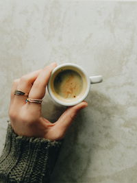 Directly above shot of woman holding coffee cup