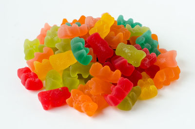 Close-up of multi colored candies against white background