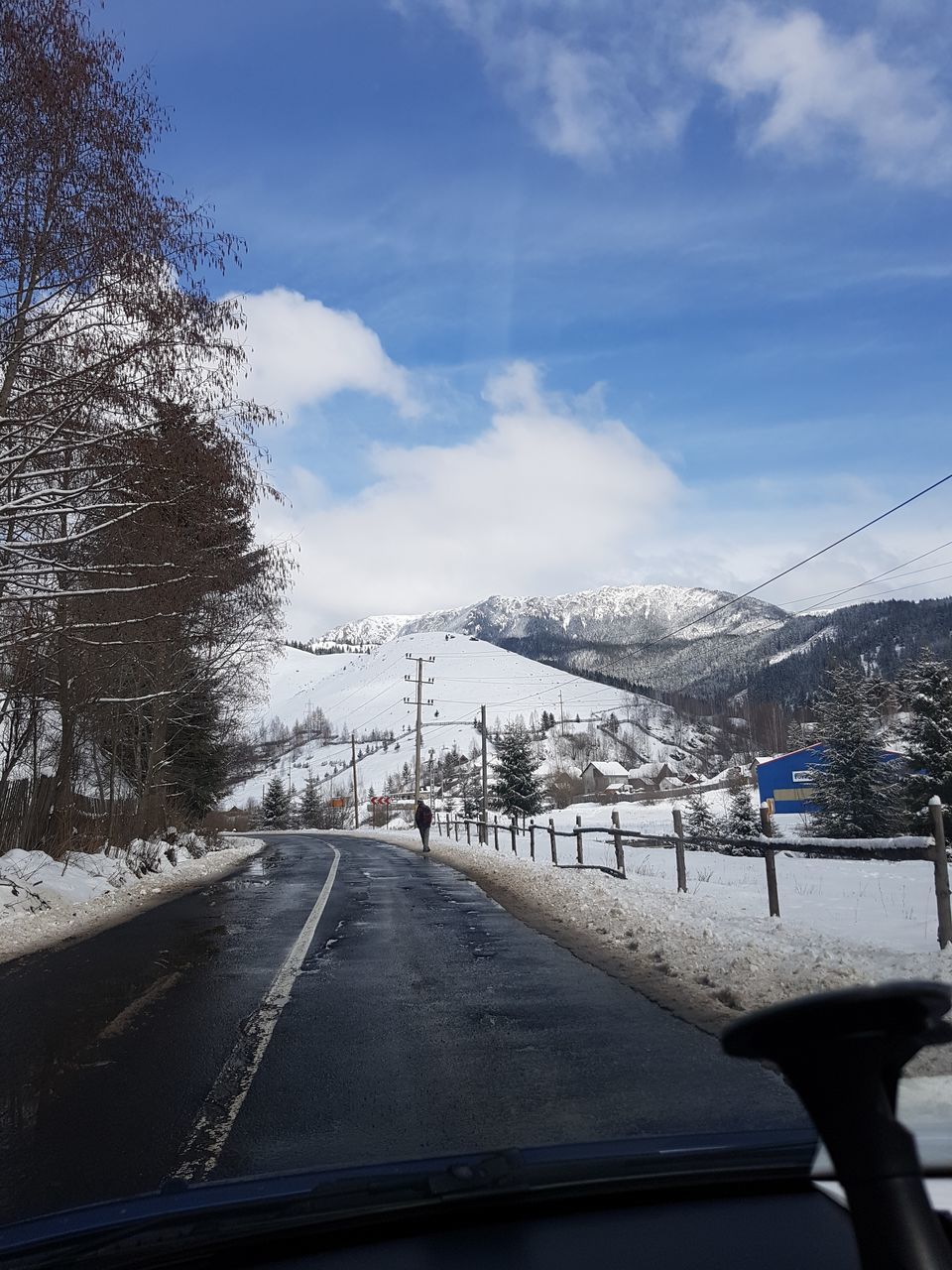 ROAD BY SNOWCAPPED MOUNTAIN AGAINST SKY