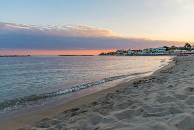 Scenic view of beach against sky during sunset