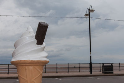 Close-up of ice cream sculpture at promenade against sky