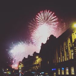 Low angle view of firework display at night