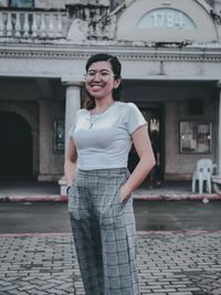 Portrait of a smiling young woman standing outdoors