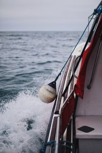 Close-up of nautical vessel on sea against sky