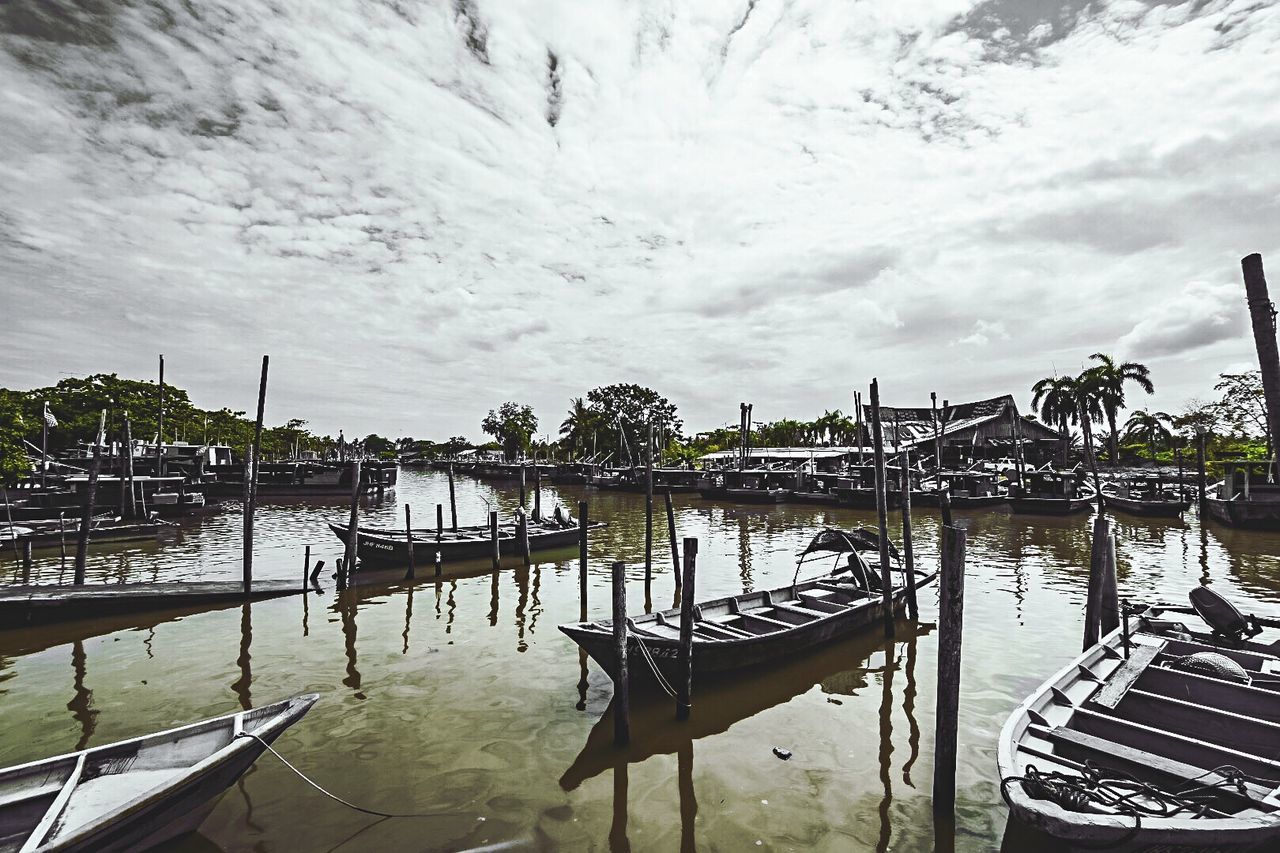 nautical vessel, water, mode of transport, transportation, moored, boat, sky, nature, cloud - sky, outdoors, day, built structure, beauty in nature, scenics, architecture, tranquility, no people, building exterior, outrigger, tree