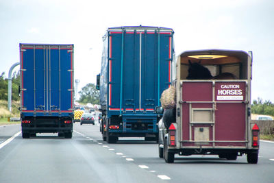 Vehicles on road against sky