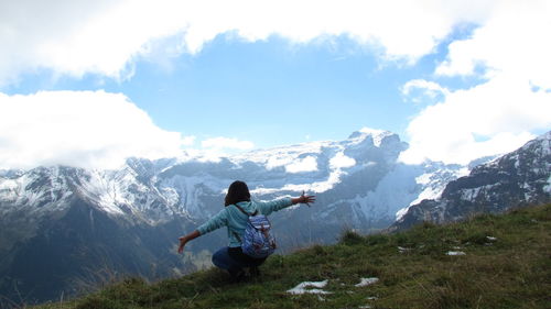 Full length of man standing on mountain against sky