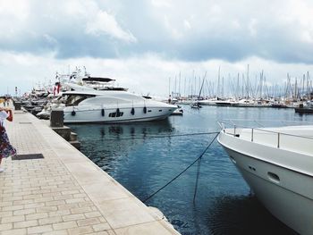 Sailboats moored at harbor