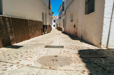 Footpath amidst buildings in town