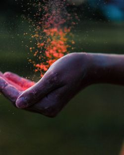 Close-up of person hand holding powder paint