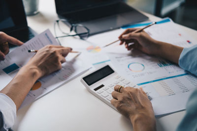High angle view of man using mobile phone on table
