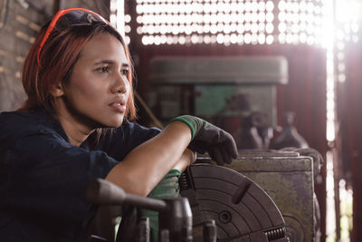 Thoughtful female mechanic at garage