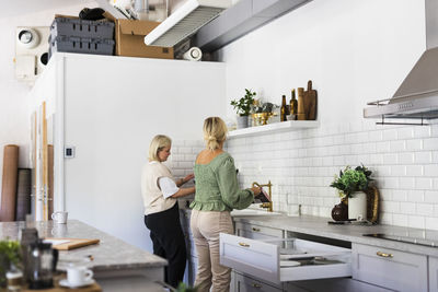 Female friends in kitchen