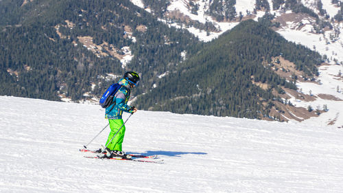 Low angle view of man skiing on snow covered mountain