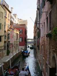 People rowing gondolas in canal