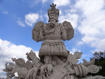 Low angle view of statue against cloudy sky