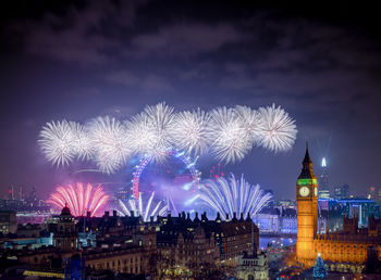 High angle view of firework display at night