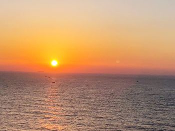 Scenic view of sea against romantic sky at sunset